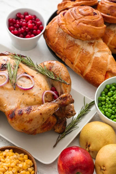 Tasty baked turkey and other dishes for Thanksgiving day on table