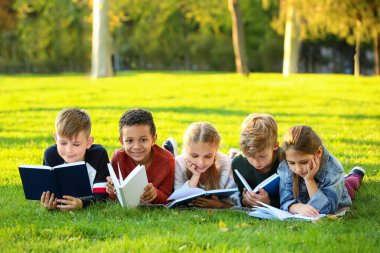 Sevimli küçük çocuklar Park kitap okuma