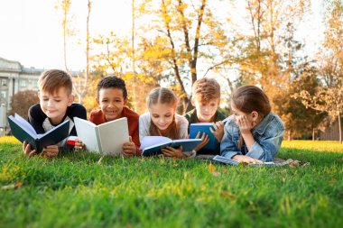 Sevimli küçük çocuklar Park kitap okuma