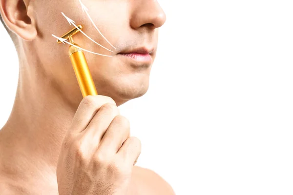 Young man massaging his face against white background, closeup — Stock Photo, Image