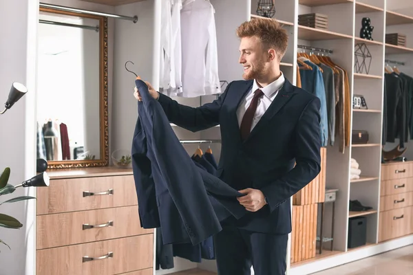 Handsome man with stylish clothes in dressing room — Stock Photo, Image