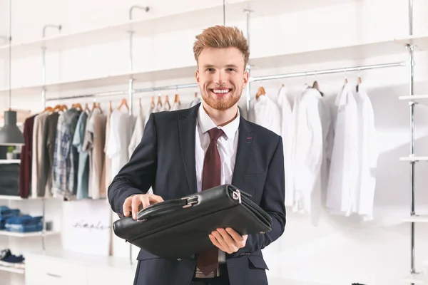 Handsome man choosing briefcase in dressing room — 스톡 사진