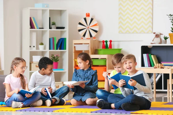 Cute little children reading books indoors — Stock Photo, Image