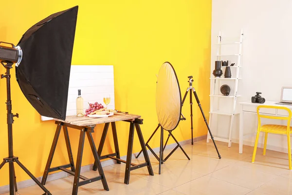 Interior of modern photo studio with professional equipment and food on table — 스톡 사진