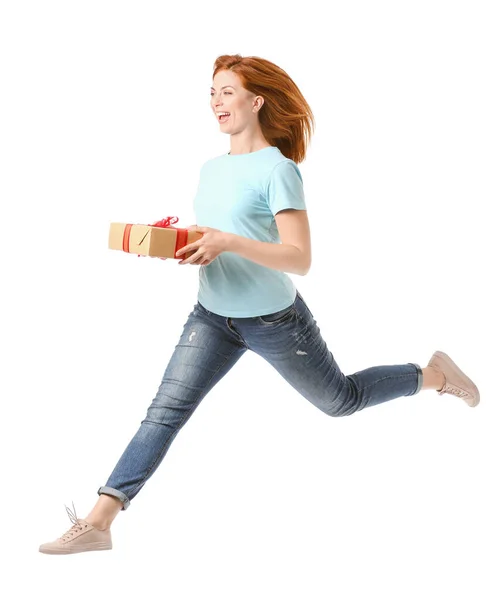 Jumping woman with gift box on white background — Stock Photo, Image