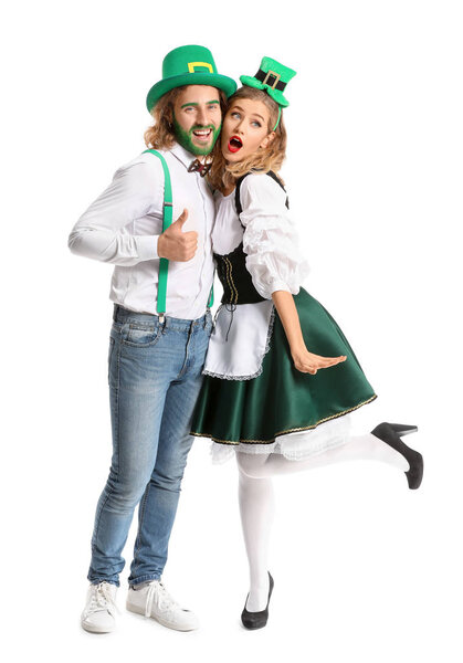 Young couple on white background. St. Patrick's Day celebration