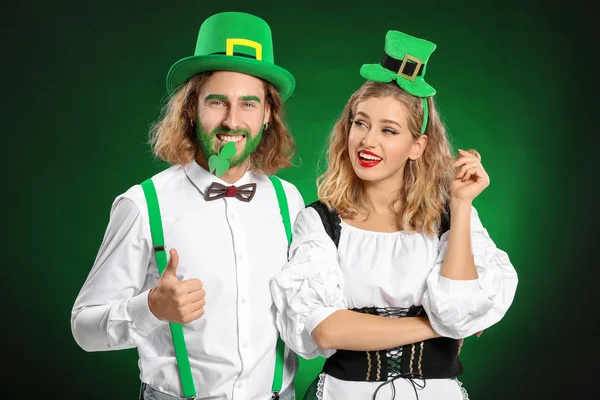 Young couple on color background. St. Patrick's Day celebration — 스톡 사진