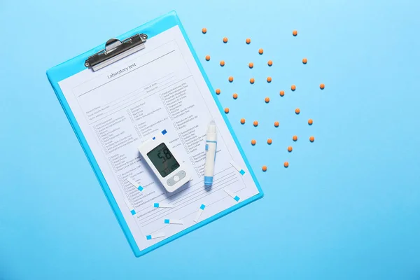 Teste de laboratório, glicosímetro, pílulas e caneta lancet no fundo de cor. Conceito de diabetes — Fotografia de Stock