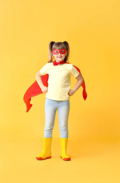 Little girl in superhero costume on color background. Concept of feminism — Stock Photo, Image