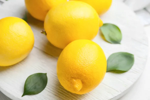 Fresh ripe lemons on white table — Stock Photo, Image