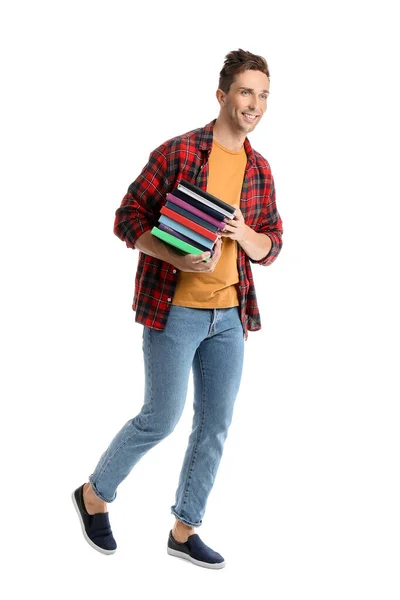 Красивый молодой человек с книгами на белом фоне — стоковое фото