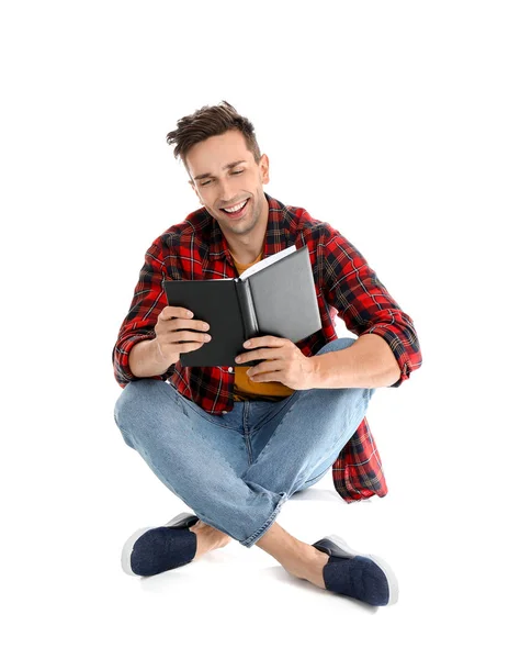 Handsome young man reading book on white background — Stock Photo, Image