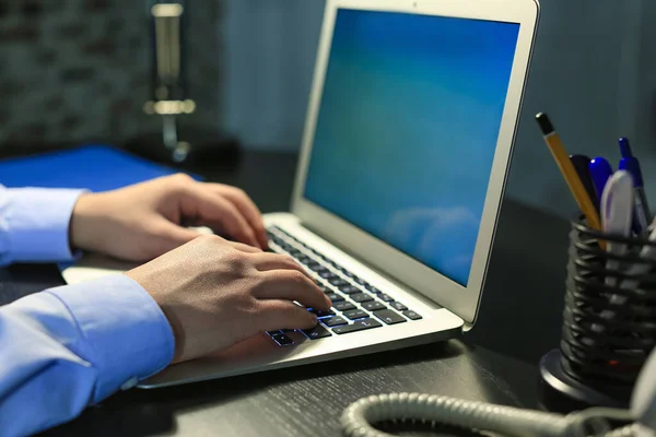 Businessman working on laptop in office late at night, closeup — Stock Photo, Image