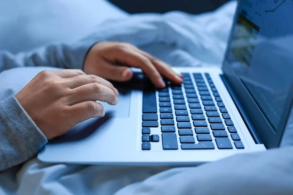 Man with laptop in bed at night, closeup — Stock Photo, Image