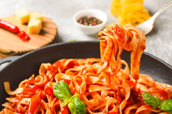 Eating of tasty pasta with tomato sauce, closeup — Stock Photo, Image