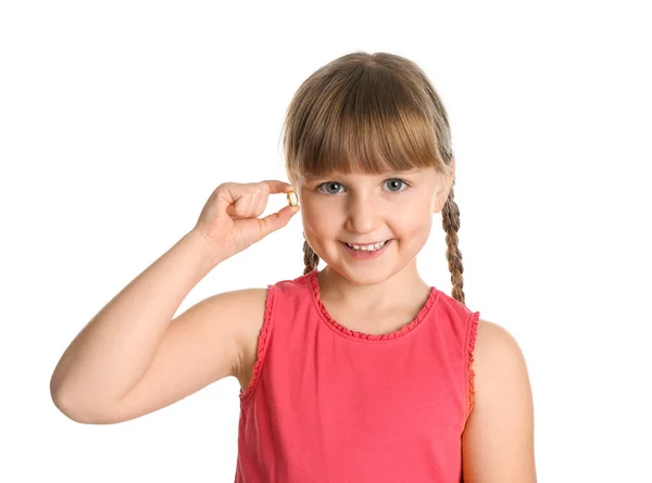 Little girl with fish oil pill on white background — Stock Photo, Image