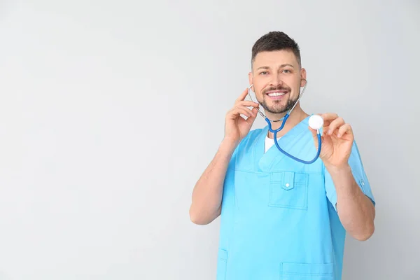 Male cardiologist on light background — Stock Photo, Image