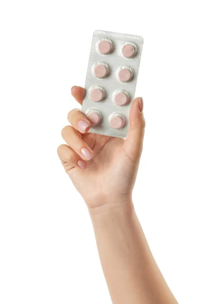 Mano femminile con pillole in blister su sfondo bianco — Foto Stock