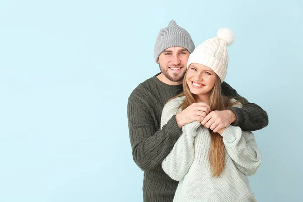Retrato de pareja feliz en ropa de invierno sobre fondo de color — Foto de Stock