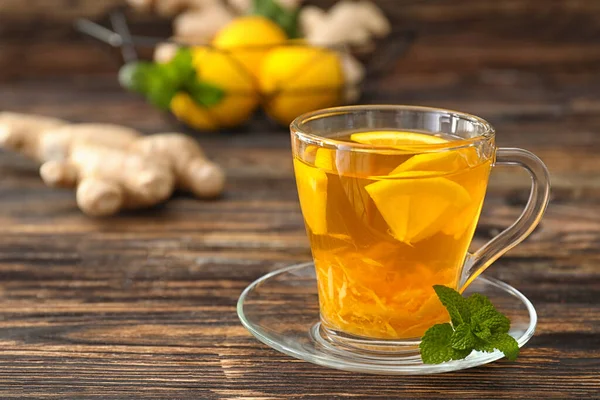 Cup of tasty ginger tea on table — 스톡 사진