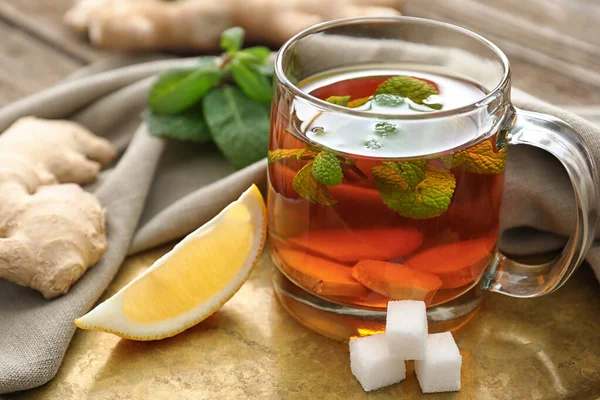 Cup of tasty ginger tea on table — Stock Photo, Image