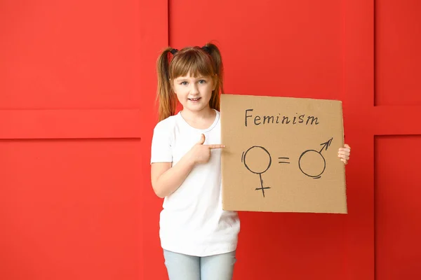 Little girl holding cardboard with symbols of man and woman on color background. Concept of feminism — 스톡 사진