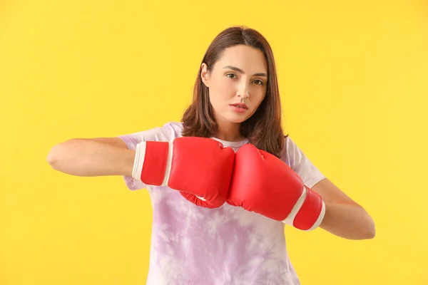 Woman in boxing gloves on color background. Concept of feminism — 스톡 사진