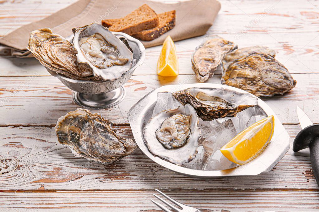 Composition with tasty oysters on wooden background