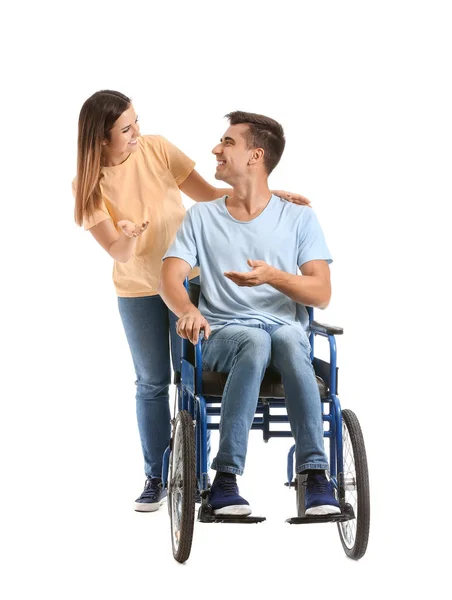 Joven discapacitado en silla de ruedas y su esposa sobre fondo blanco — Foto de Stock