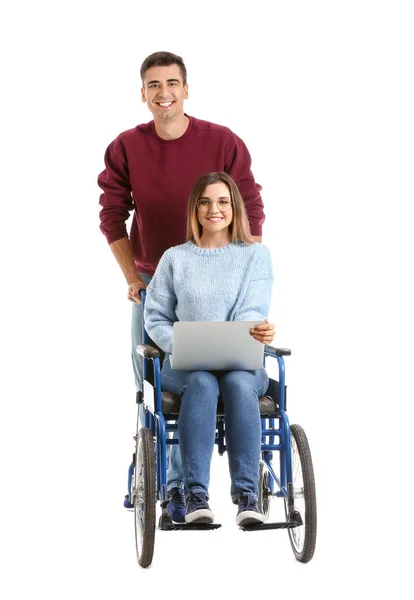 Инвалидная молодая женщина с ноутбуком и ее муж на белом фоне — стоковое фото