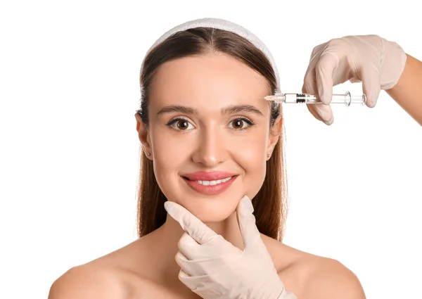 Young woman receiving filler injection against white background — Stock Photo, Image