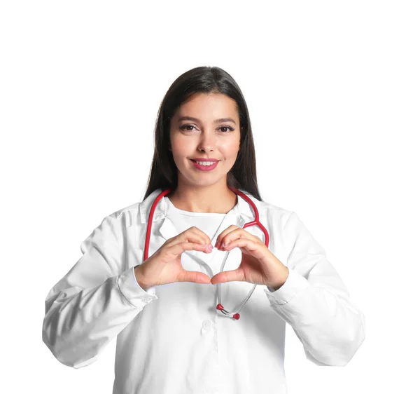 Female cardiologist making heart with her hands on white background — Stock Photo, Image