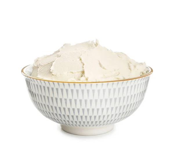 Bowl with tasty cream cheese on white background — Stock Photo, Image
