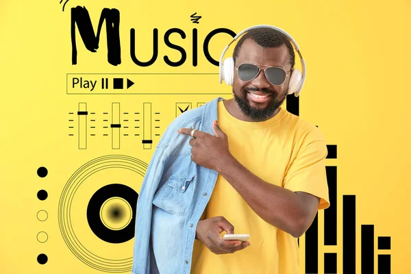 Handsome African-American man listening to music on color background — Stock Photo, Image