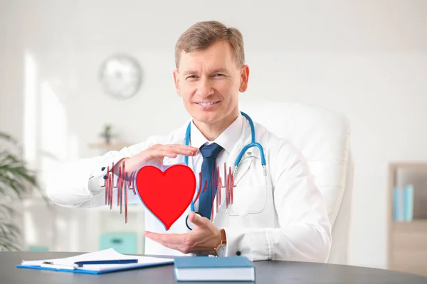 Male cardiologist with drawn heart and cardiogram in modern clinic