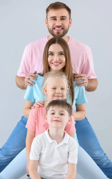 Portrait of happy family on light background — Stock Photo, Image