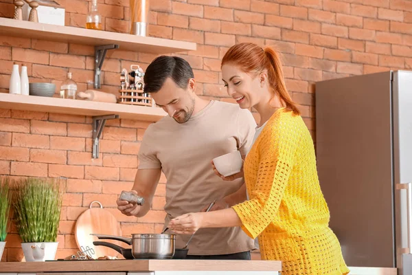 Happy couple cooking together in kitchen — Stock Photo, Image