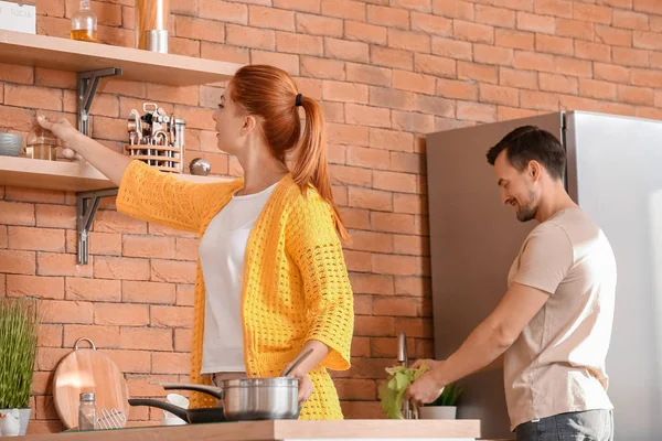 Happy couple cooking together in kitchen — Stock Photo, Image