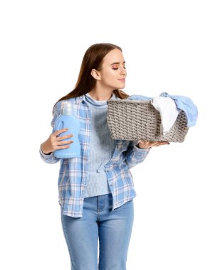 Beautiful young woman with laundry on white background