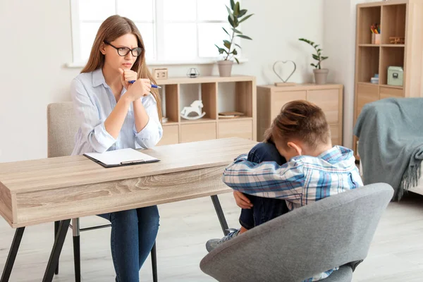 Female psychologist working with sad boy in office — Stock Photo, Image
