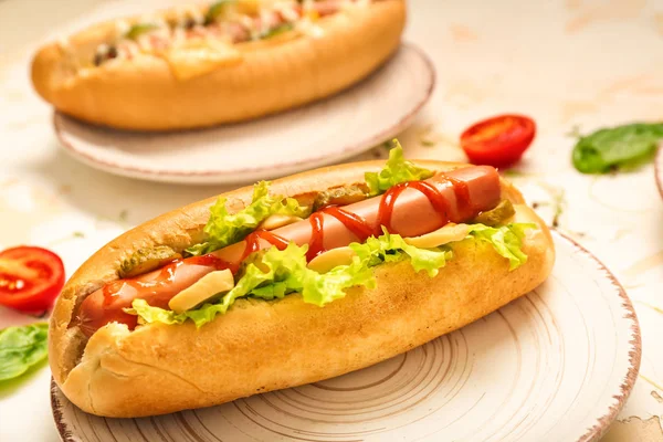Tasty hot dogs on light table — Stock Photo, Image