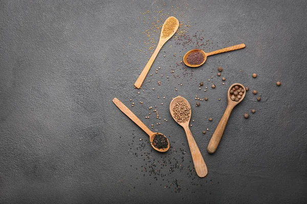 Different spices in spoons on grey background — Stock Photo, Image