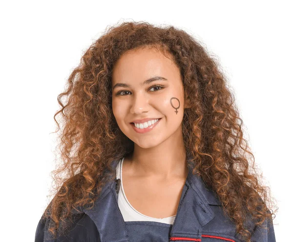 African-American female worker with symbol of woman drawn on her face against white background. Concept of feminism — Stock Photo, Image