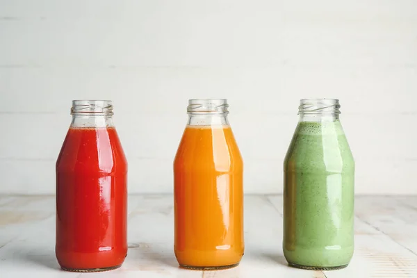 Bottles of fresh vegetable juices on table — Stock Photo, Image