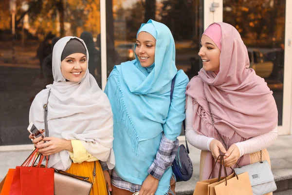 Beautiful Muslim women with shopping bags outdoors — 스톡 사진
