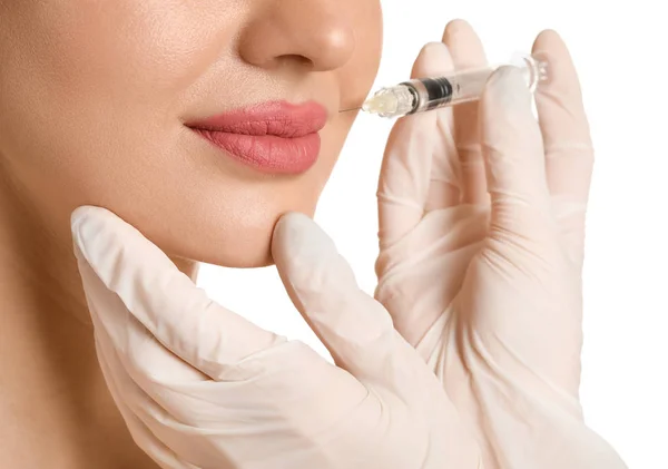 Young woman receiving filler injection against white background, closeup — Stock Photo, Image