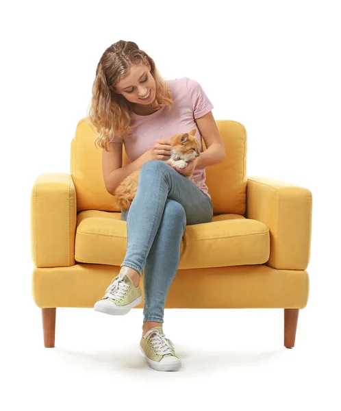 Beautiful young woman with cute cat sitting in armchair on white background — Stock Photo, Image