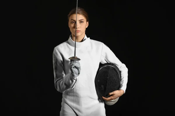 Young female fencer on dark background — Stock Photo, Image