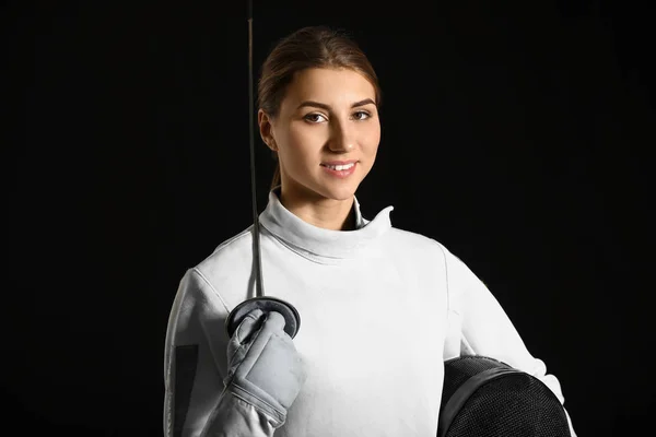 Young female fencer on dark background — Stock Photo, Image