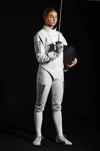 Young female fencer on dark background — Stock Photo, Image